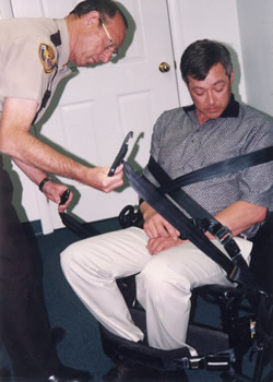 Sheriff Don Beckstead strapping in Paul Kraxberger